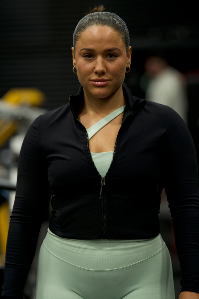 The coach is posing with her confidence.