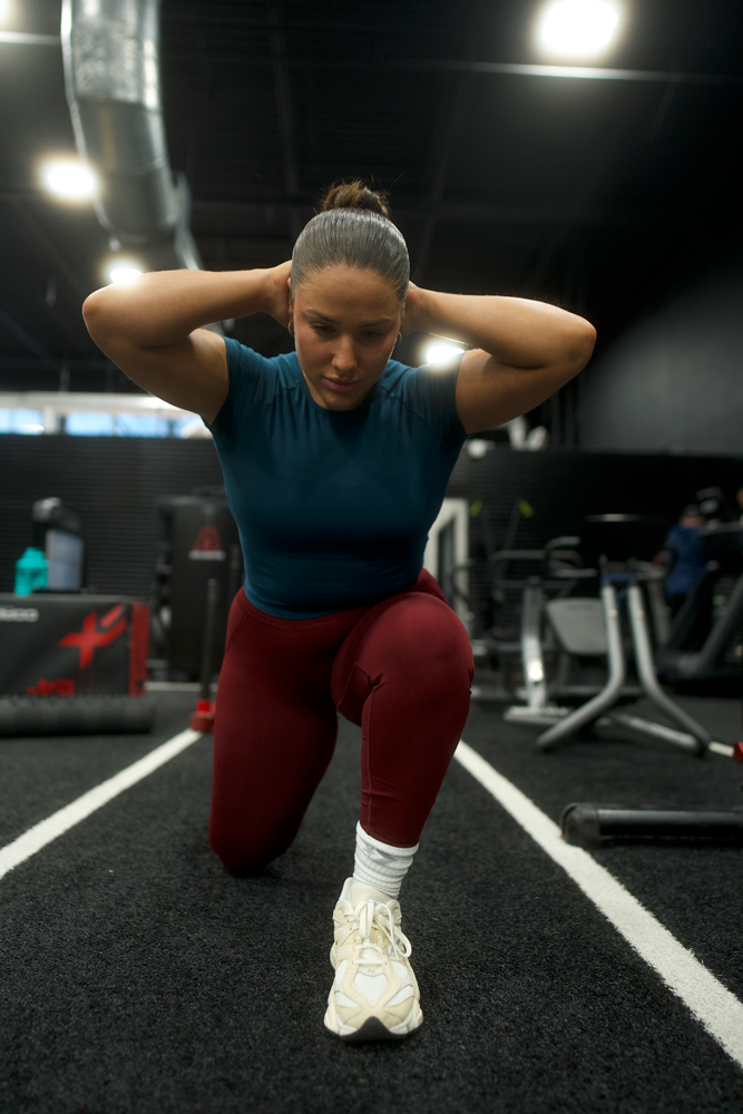 The coach is stretching her body.